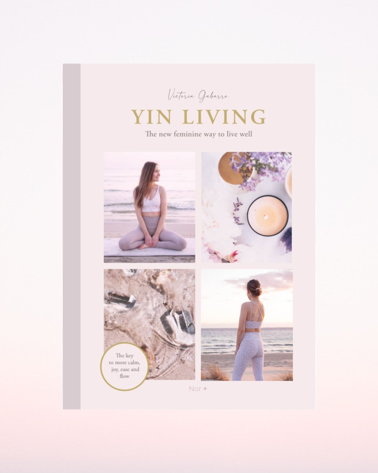 Book titled 'Yin Living' by Victoria Gabarro on a light pink background